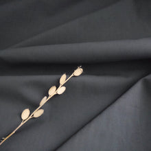 Load image into Gallery viewer, Organic Candy Cotton Fabric with soft folds displayed with a dried flower stem