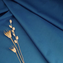 Load image into Gallery viewer, Organic Cotton fabric displayed in gentle folds with dried flower stems