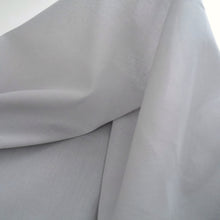 Load image into Gallery viewer, Organic Cotton Voile hung against light shows sheerness and drape