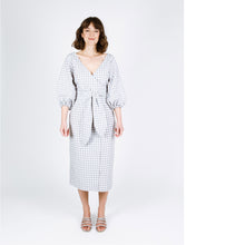 Load image into Gallery viewer, Lady wears below knee length wrap dress with waist ties in a gingham fabric