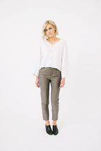 Load image into Gallery viewer, Lady wears a V neck button front Nexus Blouse with long wide sleeves