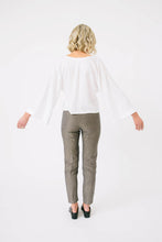 Load image into Gallery viewer, Back of view of lady holding out arms to show wide flare sleeves of Nexus Blouse