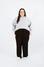 Load image into Gallery viewer, Lady wears variation three of the Pinnacle Top, a long sleeved sweatshirt with neck band and cuffs