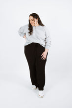 Load image into Gallery viewer, Lady wears variation three of the Pinnacle Top, a long sleeved sweatshirt with neck band and cuffs