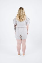Load image into Gallery viewer, Back view of lady wearing Solar Tee with ruffles on sleeves