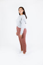 Load image into Gallery viewer, Side view of lady wearing Solar Tee with ruffles over long sleeves