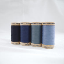 Load image into Gallery viewer, Four wooden reels of Scanfil Organic Cotton Thread in Midnight, Sapphire, Stormy Blue and Dusk colours.