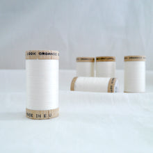 Load image into Gallery viewer, Collection of five wooden spools of organic cotton sewing thread in a Natural colour.