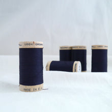 Load image into Gallery viewer, Five wooden reels of organic cotton sewing thread in a dark navy midnight blue.