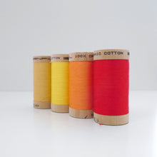 Load image into Gallery viewer, Four wooden reels of organic cotton sewing thread in different colours