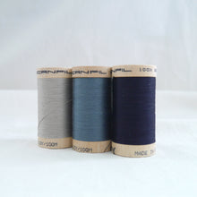 Load image into Gallery viewer, Three wooden reels of a grey, a dusky blue, and a dark navy blue.
