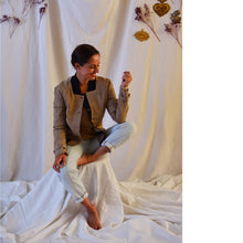 Load image into Gallery viewer, Lady sat down wears Sunset jacket made of plaid fabric with contrasting black collar.
