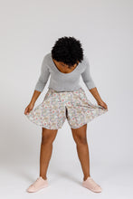 Load image into Gallery viewer, Lady bends forward, holding out the flare of the Tania Culottes