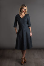 Load image into Gallery viewer, Lady wears V-neck dress with A-line skirt. Right hand in side seam pocket.