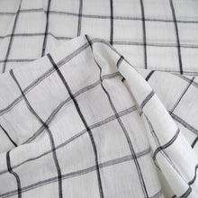 Load image into Gallery viewer, White and black box check pattern linen fabric scrunched to show crisp and sheerness