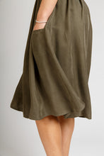 Load image into Gallery viewer, Close up of hand in pocket of knee-length Brumby Skirt, slightly swishing.