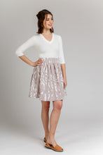 Load image into Gallery viewer, Lady wears an above-knee-length Brumby Skirt. Gathered at waistband, hand on hip.