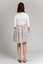 Load image into Gallery viewer, Back view of lady wearing an above-knee-length Brumby skirt, shows exposed metallic zip at centre back waistband.