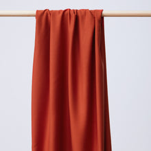 Load image into Gallery viewer, EcoVero Viscose Fabric hangs and drapes over a wooden pole