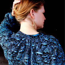 Load image into Gallery viewer, Back view of lady wearing Sille Shirt holds up her hair to show off gathers at collar stand neckline.