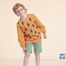 Load image into Gallery viewer, Young person wears sweatshirt made with Penguins Bedtime French Terry fabric
