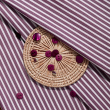 Load image into Gallery viewer, Close up of Stripe Sunray Viscose Modal fabric with wicker coaster of buttons lain on top
