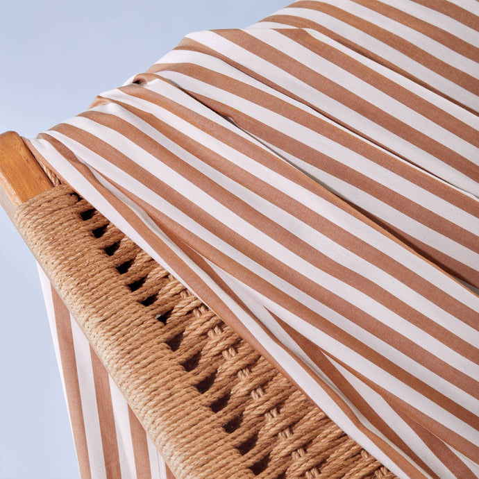 Close up of Sunray Stripe Viscose Modal fabric draped over wicker chair