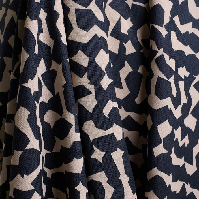 Atelier Brunette's Ekko Viscose fabric hangs to show drape, with an abstract blocks pattern print