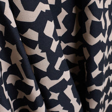 Load image into Gallery viewer, Close up of Atelier Brunette&#39;s Ekko Viscose fabric shows drape, with an abstract blocks pattern print
