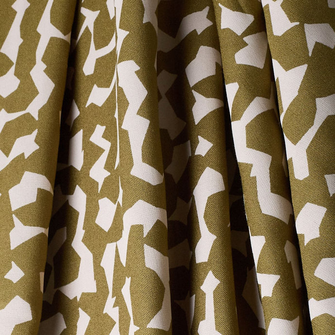 Atelier Brunette's Ekko Viscose fabric hangs to show drape, with an abstract blocks pattern print