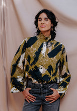 Load image into Gallery viewer, Model wears a stand collar, button-up shirt made in Atelier Brunette&#39;s Mira Viscose fabric.
