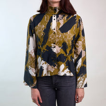 Load image into Gallery viewer, Model wears a stand collar, button-up shirt made in Atelier Brunette&#39;s Mira Viscose fabric
