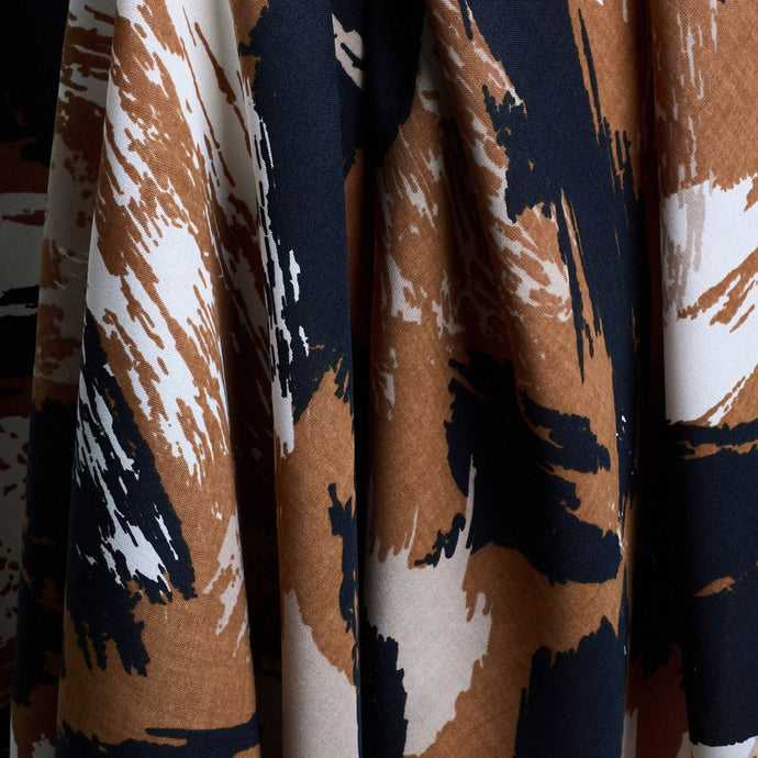 Atelier Brunette's Mira Viscose fabric hangs to show drape close-up, with an abstract brushstrokes pattern print