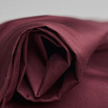 Load image into Gallery viewer, Close up of folded end, roll of Oxford Cotton fabric
