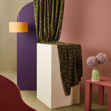 Load image into Gallery viewer, Printed Viscose fabric hangs from above onto a cuboid stand with heavy drape

