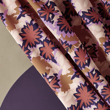 Load image into Gallery viewer, Diagonal view of viscose fabric hanging with a waterlily abstract print on it
