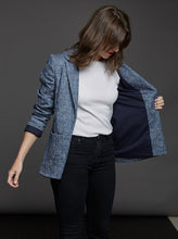 Load image into Gallery viewer, Lady wears The Blazer with sleeves ruched up arm, holds open one side to show full lined jacket

