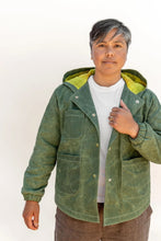 Load image into Gallery viewer, Model wears a hooded Beachcomber Jacket with four patch pockets at front
