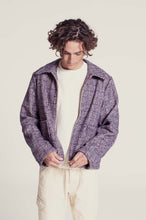 Load image into Gallery viewer, Model wears a Bear Jacket made with wool check fabric; fastening the zipper
