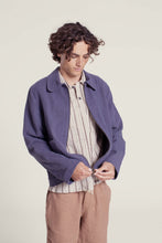 Load image into Gallery viewer, Model wears a Bear Jacket made with soft twill fabric; fastening the zipper

