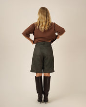 Load image into Gallery viewer, Back view of model wearing Bermuda Shorts, with patch pockets at hip level
