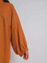 Load image into Gallery viewer, Back view of lady wearing Zero Waste Dress with long sleeves, gathered into a cuff band

