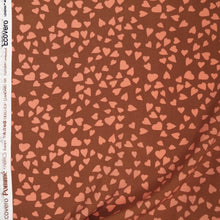 Load image into Gallery viewer, Viscose fabric with hearts pattern, displayed with selvedge
