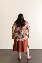 Load image into Gallery viewer, Back view of lady wearing a Butano Button Up, worn with skirt
