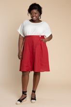Load image into Gallery viewer, Lady wears an asymmetrical wrap Fiore Skirt, knee-length flare skirt
