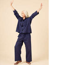 Load image into Gallery viewer, Lady wears a pyjama set with arms outstretched
