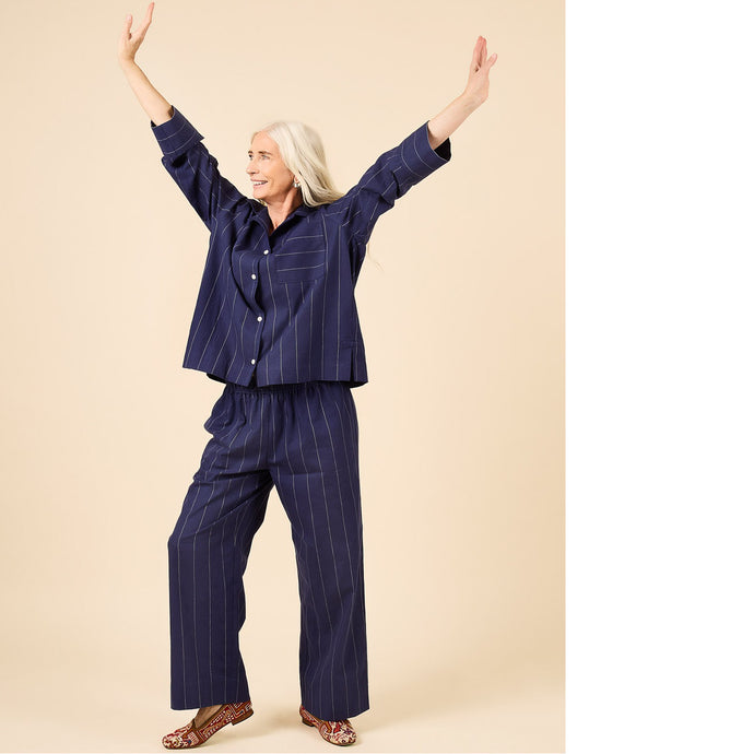 Lady wears a pyjama set with arms outstretched