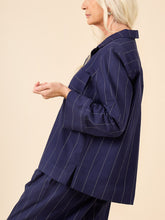 Load image into Gallery viewer, Detail of wide cuff on pyjama top sleeve, stripes on fabric going in different direction to the rest of the sleeve
