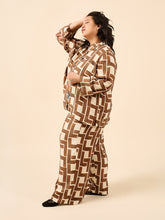 Load image into Gallery viewer, Side view of lady wearing pyjama set in a bold print fabric
