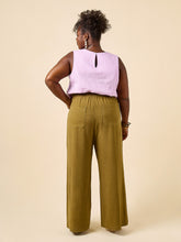 Load image into Gallery viewer, Back view of model wearing wide leg trousers with patch pockets and drawstring paperbag waist
